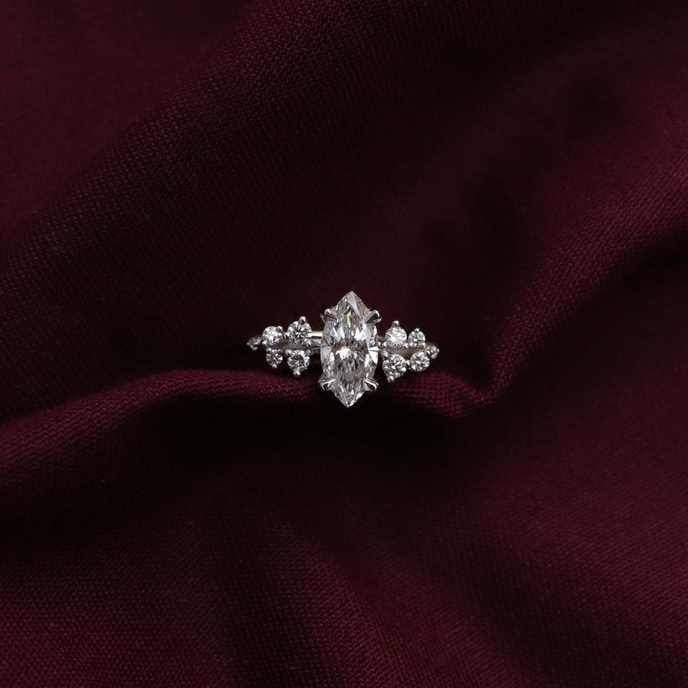 
                      
                        The Aurora Ring - Marquise with Round Brilliant Accents
                      
                    