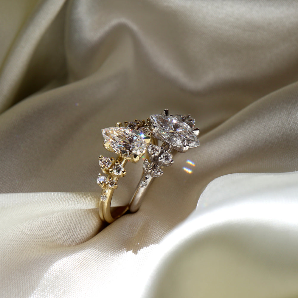 
                      
                        The Aurora Ring - Pear with Round Brilliant Accents
                      
                    