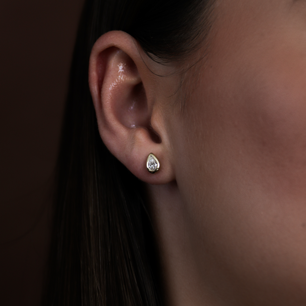 
                      
                        The Vera Earrings - Pear Bezel Studs
                      
                    