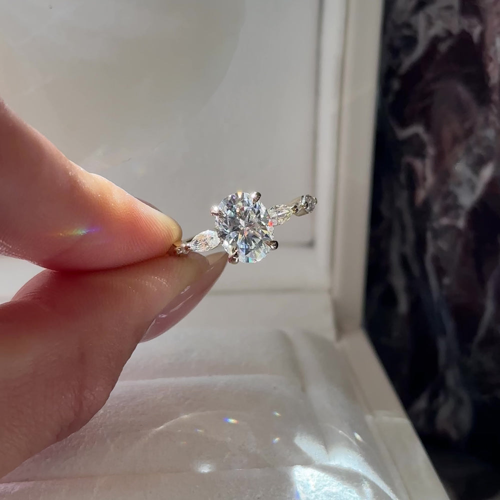 
                      
                        Load and play video in Gallery viewer, The Avery Ring - 2.1ct Moissanite Oval Solitaire with Marquise Band
                      
                    