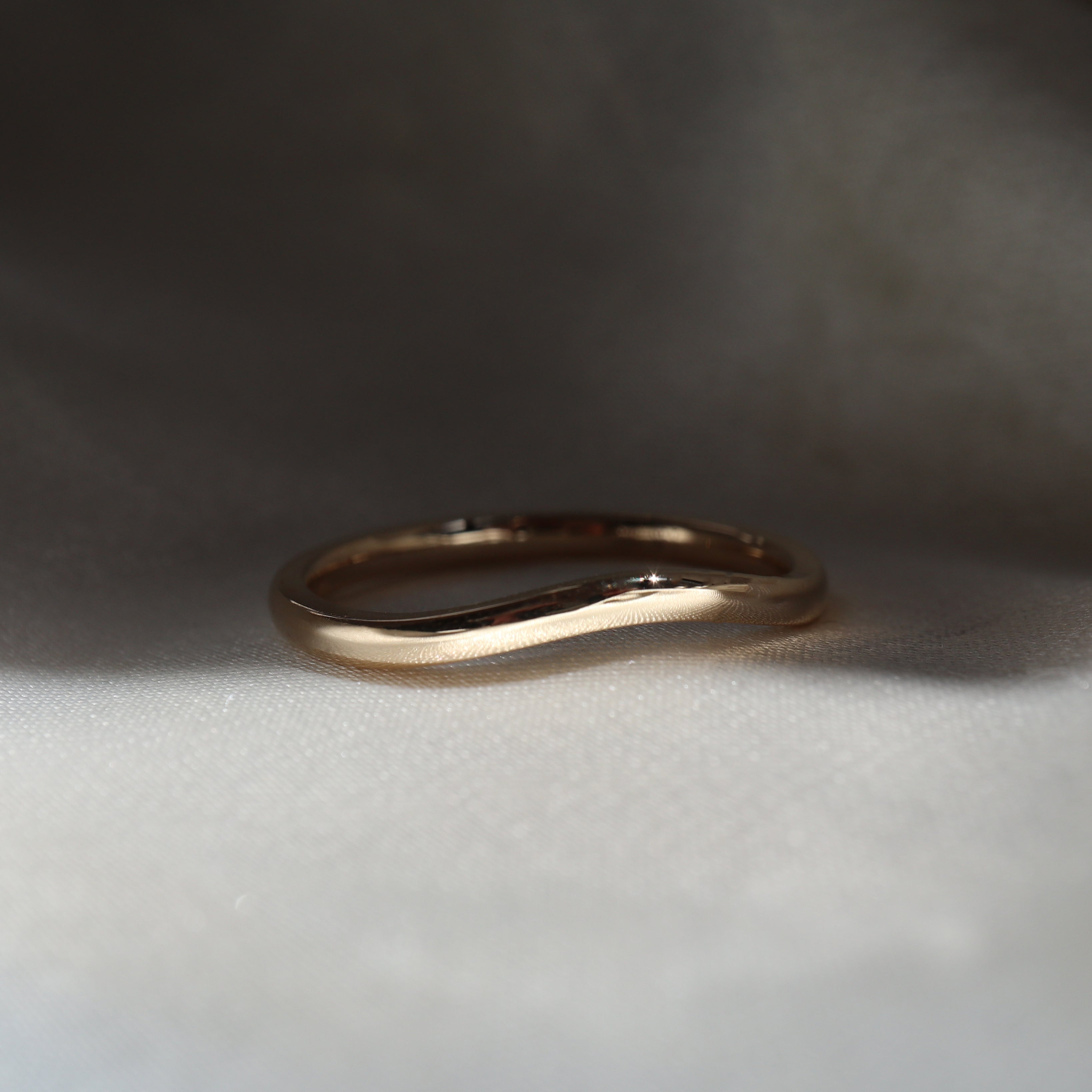 Thin curved store wedding band